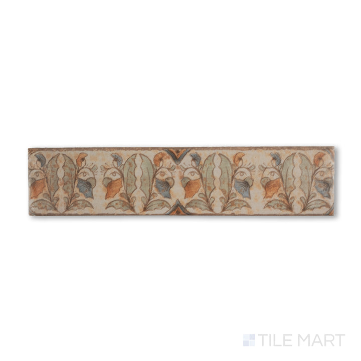 Top-down shot of Cotto Nature Tira Versilia 3x14 gloss porcelain liner, showcasing hand-painted scrolling patterns with a refined, glossy surface.