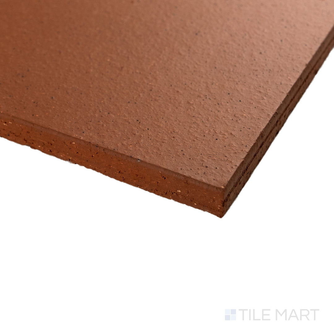 Corner close-up of Metropolitan Mayflower Red 6x6 honed quarry tile showing deep red tone and smooth matte surface.
