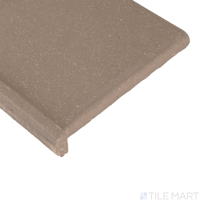 Corner close-up of Metropolitan Puritan Gray 6x6 honed quarry cove base left corner highlighting smooth curve and fine texture.