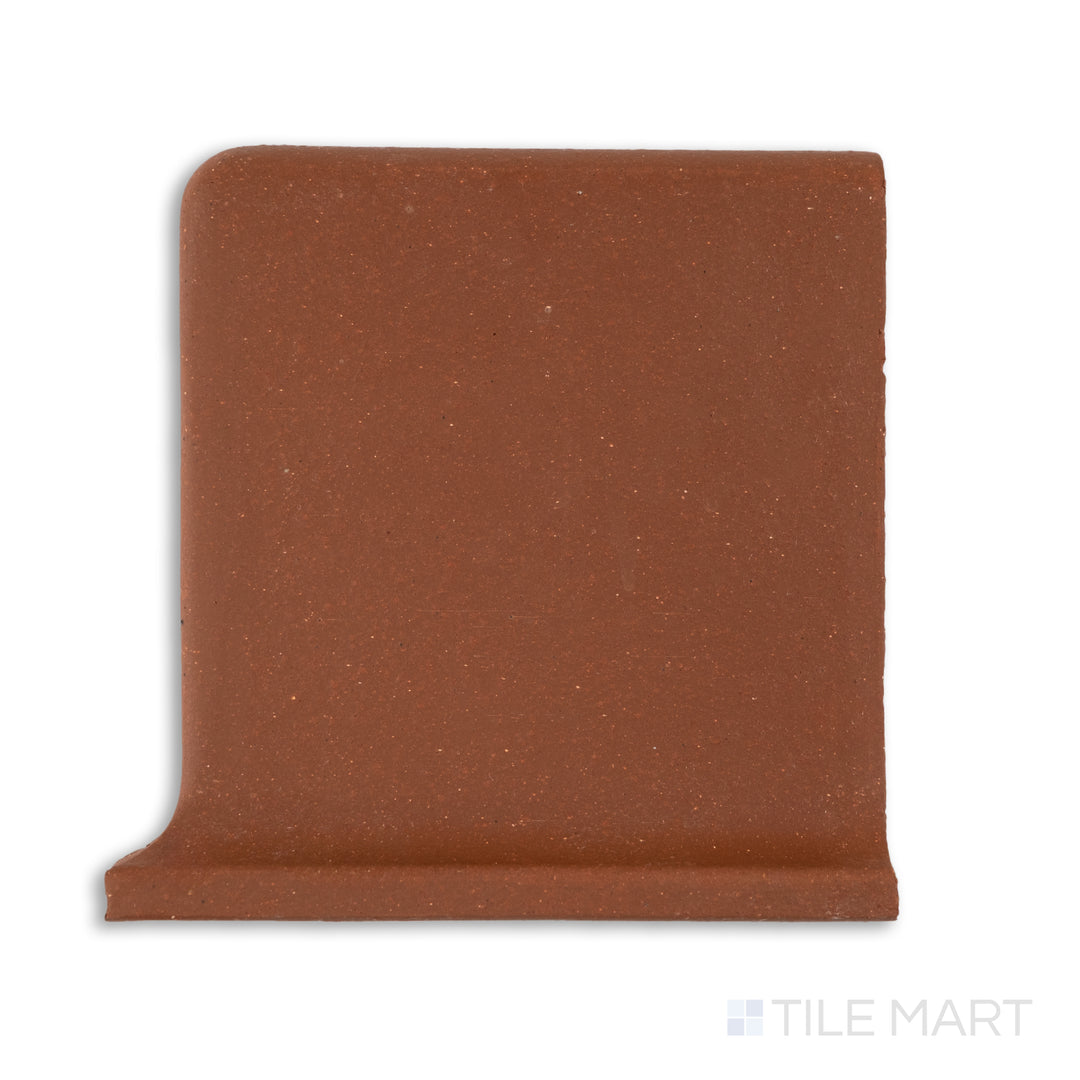 Top-down shot of Metropolitan Mayflower Red 6x6 honed quarry cove base right corner tile, presenting a rounded right-side return in classic red quarry finish.