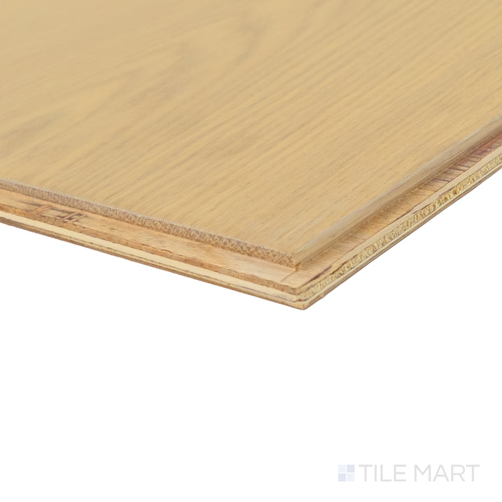 Corner close-up of Maison Un 9.5x87 engineered hardwood showing subtle grain variation and light natural finish.