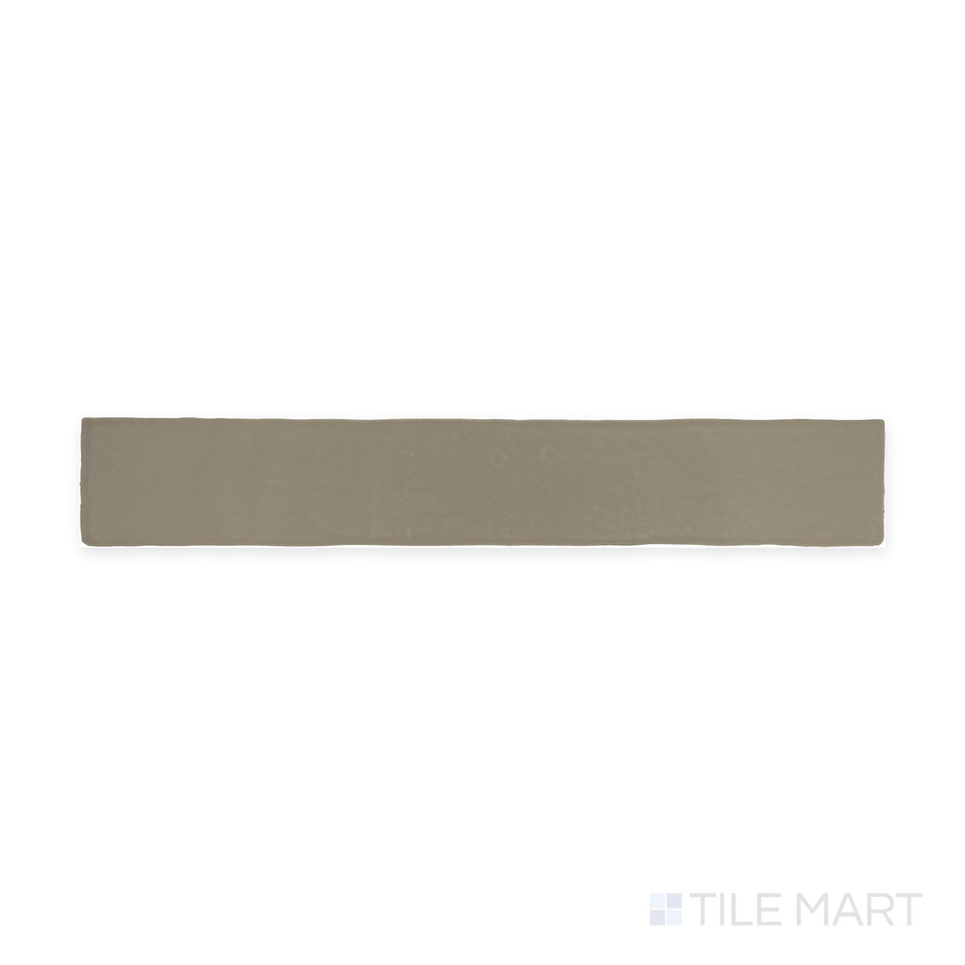 The overhead perspective showcases the Farrier Grullo 2.5x15 satin glazed ceramic tile, featuring a muted taupe-gray color with a silky satin surface, bringing subtle sophistication to any space.