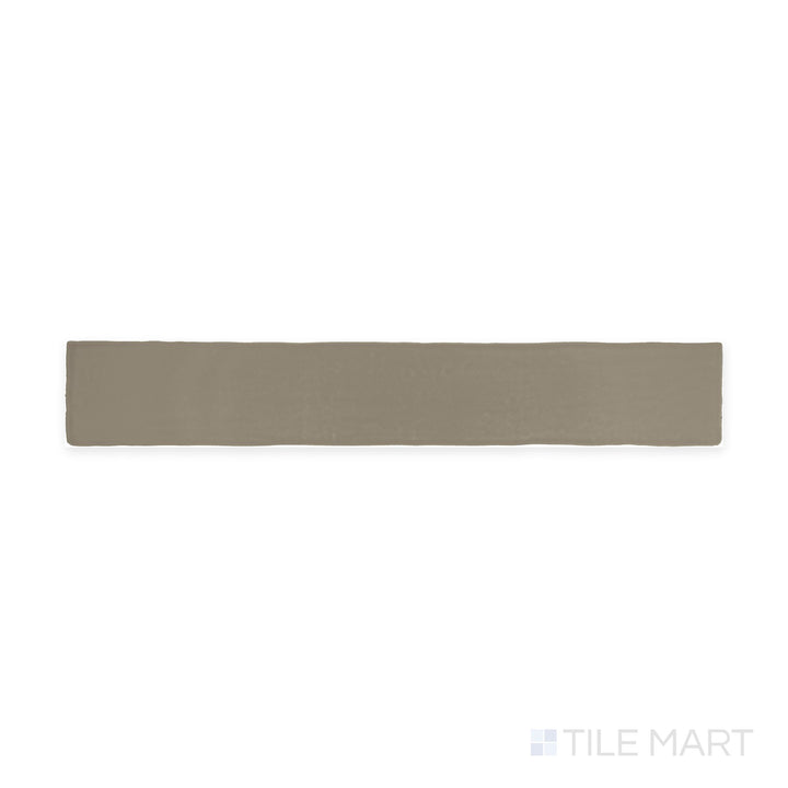 The overhead perspective showcases the Farrier Grullo 2.5x15 satin glazed ceramic tile, featuring a muted taupe-gray color with a silky satin surface, bringing subtle sophistication to any space.