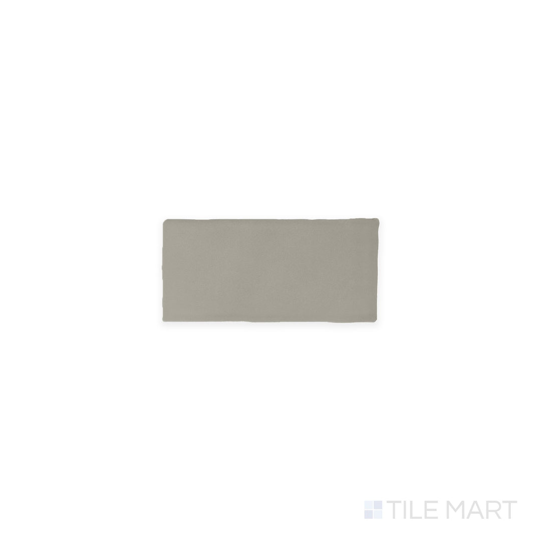 Captured from above, the Farrier Dartmoor Grey 2.5x5 satin glazed ceramic tile presents a deep gray tone with a subtle satin sheen, adding depth and modern appeal to any setting.