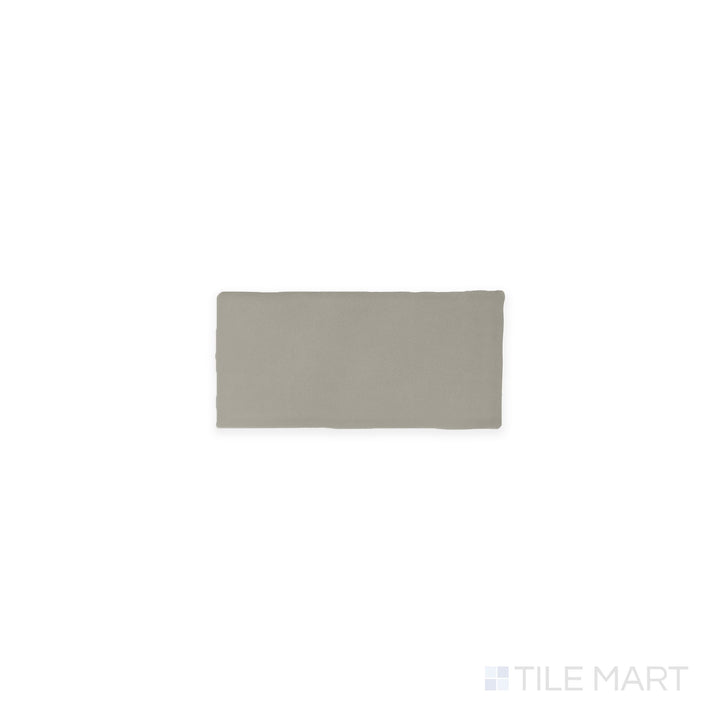 Captured from above, the Farrier Dartmoor Grey 2.5x5 satin glazed ceramic tile presents a deep gray tone with a subtle satin sheen, adding depth and modern appeal to any setting.