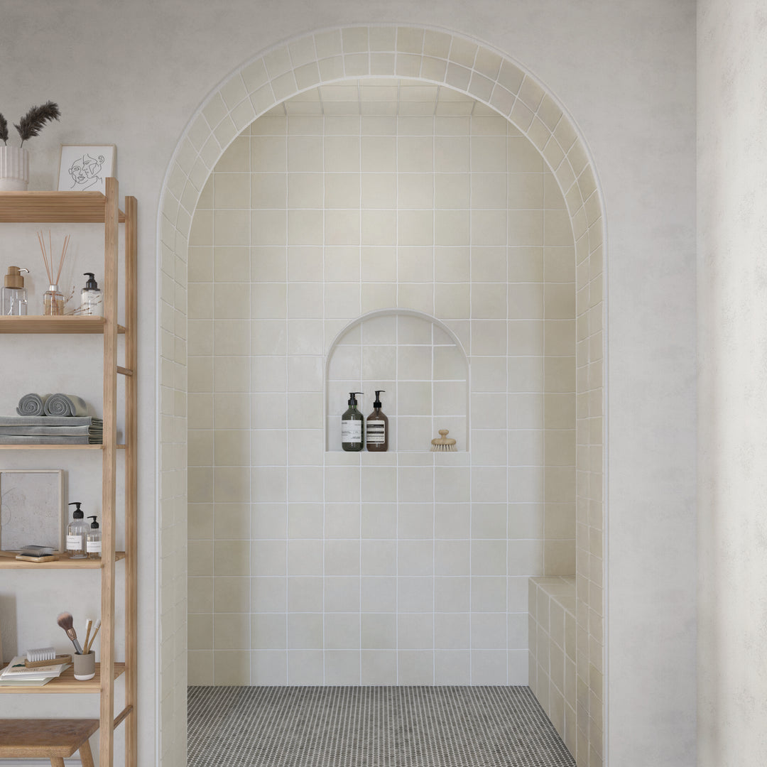 Shown in a finished interior space, the Farrier Andalusian Grey 5x5 satin glazed ceramic tile brings subtle texture and a classic square format