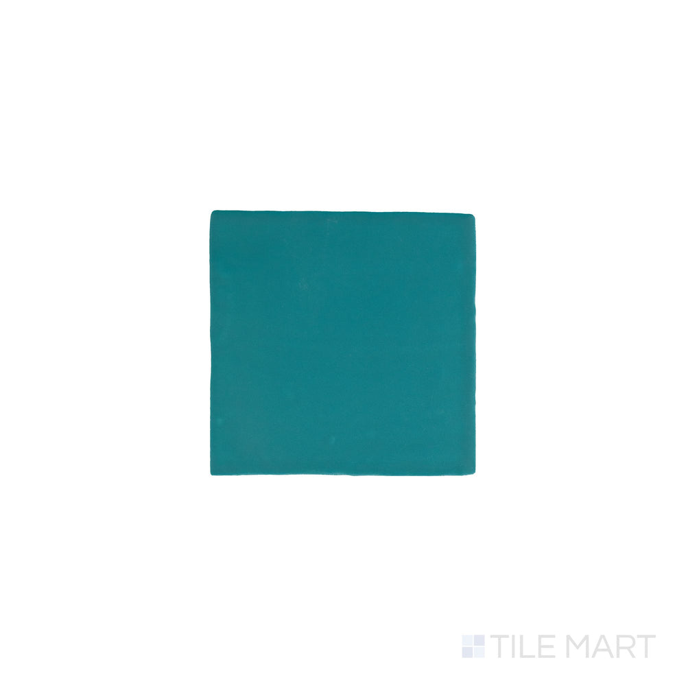 Slanted perspective of Farrier Blue Roan 5x5 satin glazed ceramic tile, emphasizing its muted blue-gray hues, smooth satin surface, and contemporary square layout.  
