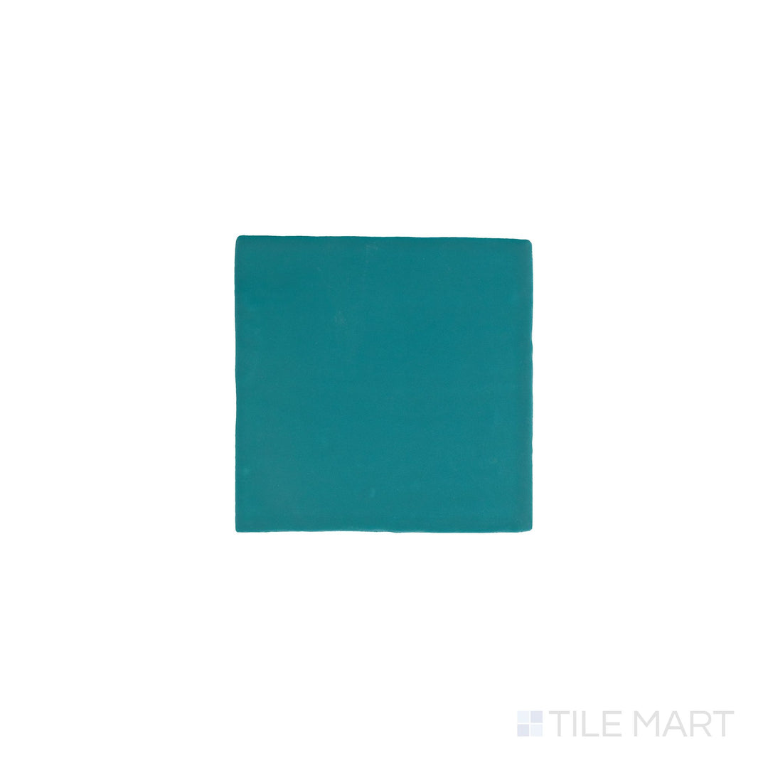 Slanted perspective of Farrier Blue Roan 5x5 satin glazed ceramic tile, emphasizing its muted blue-gray hues, smooth satin surface, and contemporary square layout.  