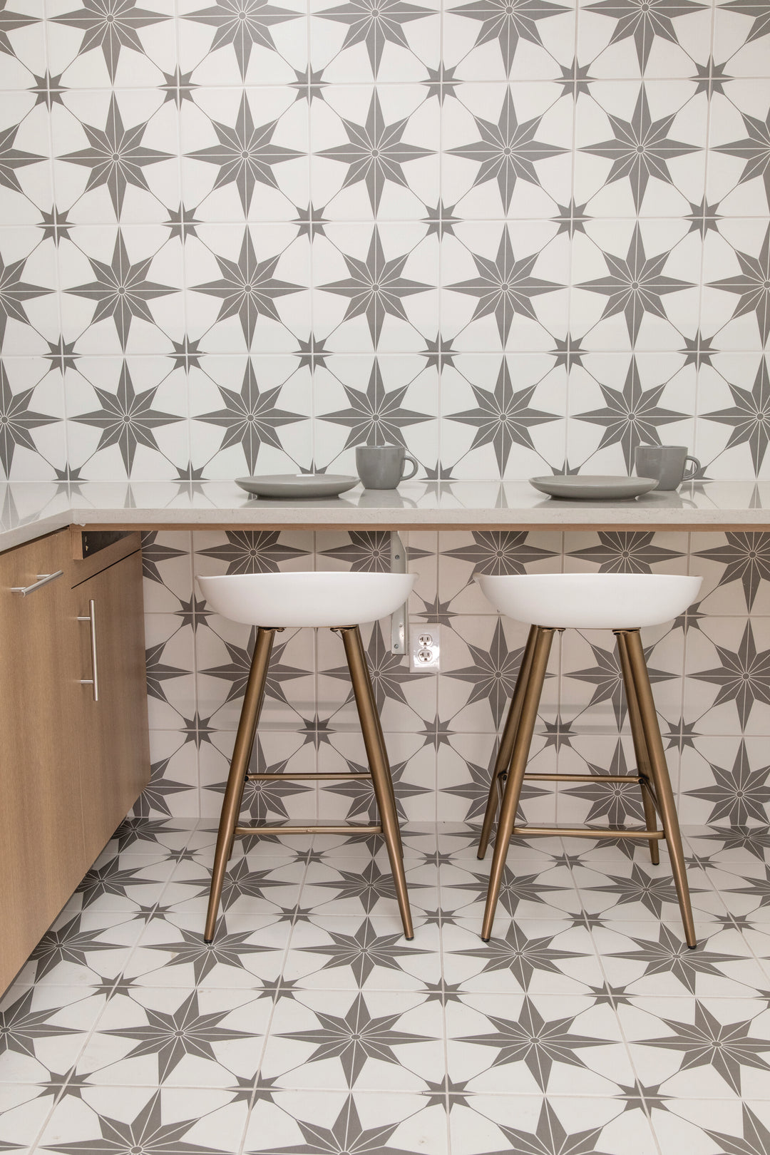 Shown in a completed interior, the Memoir Jewel Grey 12x12 matte glazed ceramic tile creates a balanced, modern look with a soft gray tone