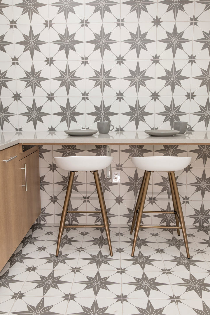 Shown in a completed interior, the Memoir Jewel Grey 12x12 matte glazed ceramic tile creates a balanced, modern look with a soft gray tone