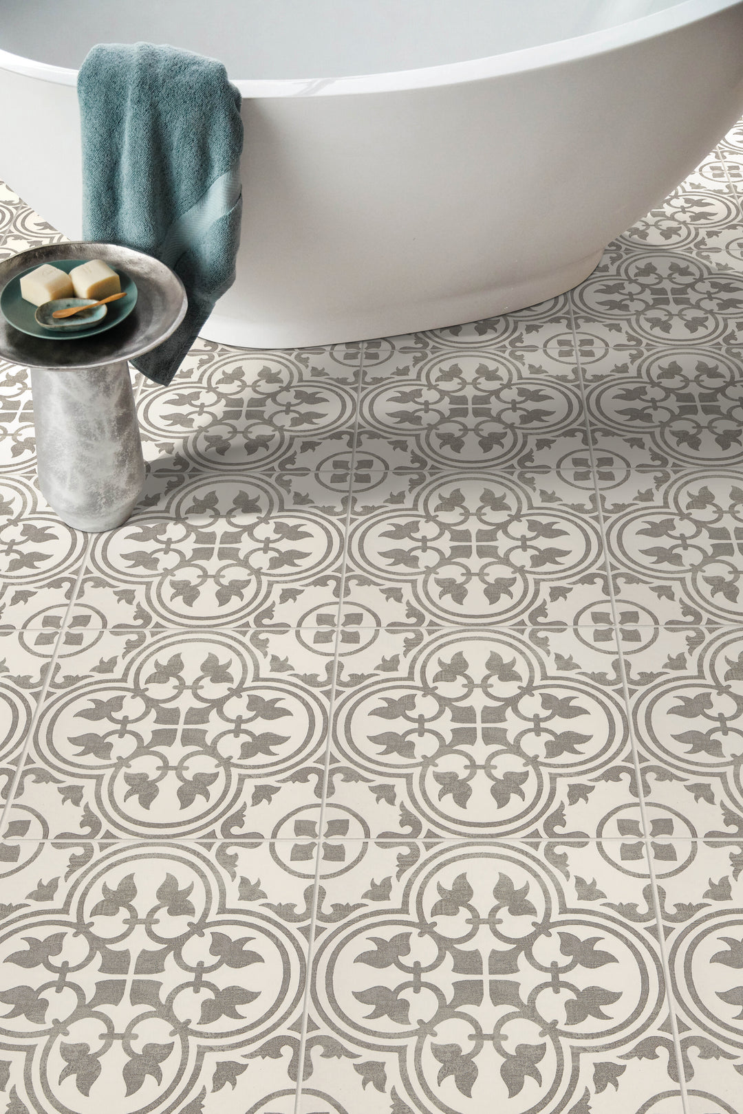 Roomscene of Memoir Petal Grey 12x12 matte glazed ceramic tile showcasing a soft floral motif and smooth matte finish in a neutral grey palette.