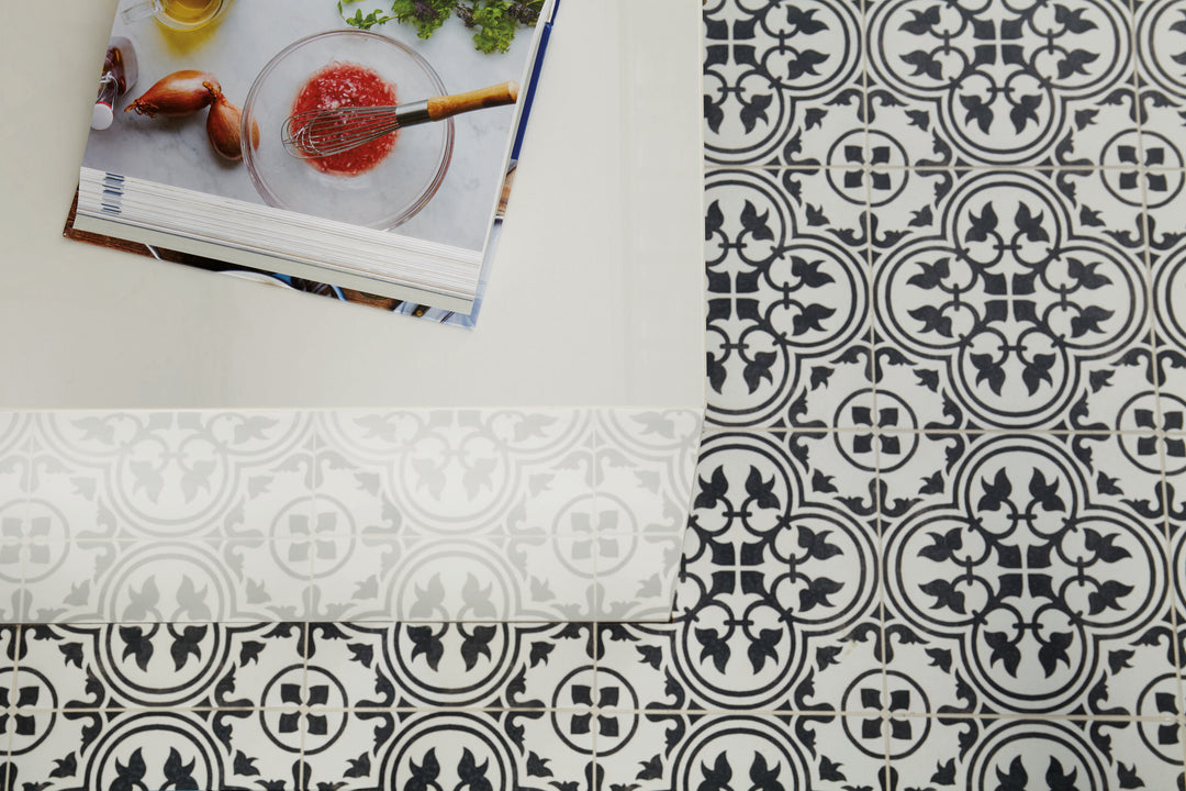 Roomscene of Memoir Petal Black 12x12 matte glazed ceramic tile highlighting a bold floral-inspired design with deep black tones and a modern matte surface.