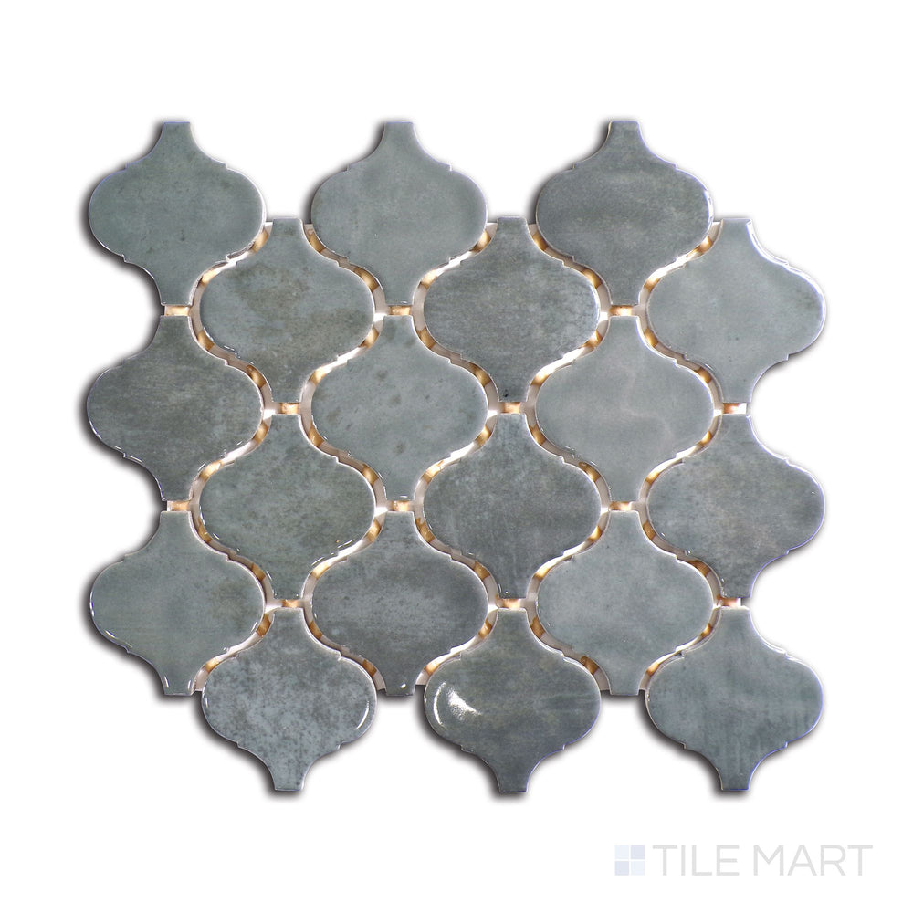 Slanted perspective of Mesmerist Charm Arabesque glossy glazed ceramic mosaic, emphasizing its sophisticated curves, glossy reflective surface, and timeless arabesque style.  