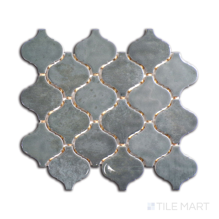 Slanted perspective of Mesmerist Charm Arabesque glossy glazed ceramic mosaic, emphasizing its sophisticated curves, glossy reflective surface, and timeless arabesque style.  