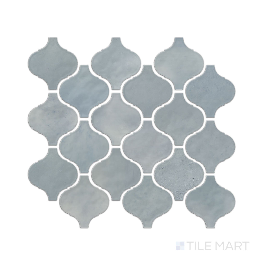 This image shows a single Mesmerist Whimsy arabesque glossy glazed ceramic mosaic piece photographed from a top-down perspective