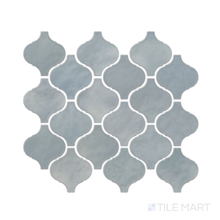 This image shows a single Mesmerist Whimsy arabesque glossy glazed ceramic mosaic piece photographed from a top-down perspective