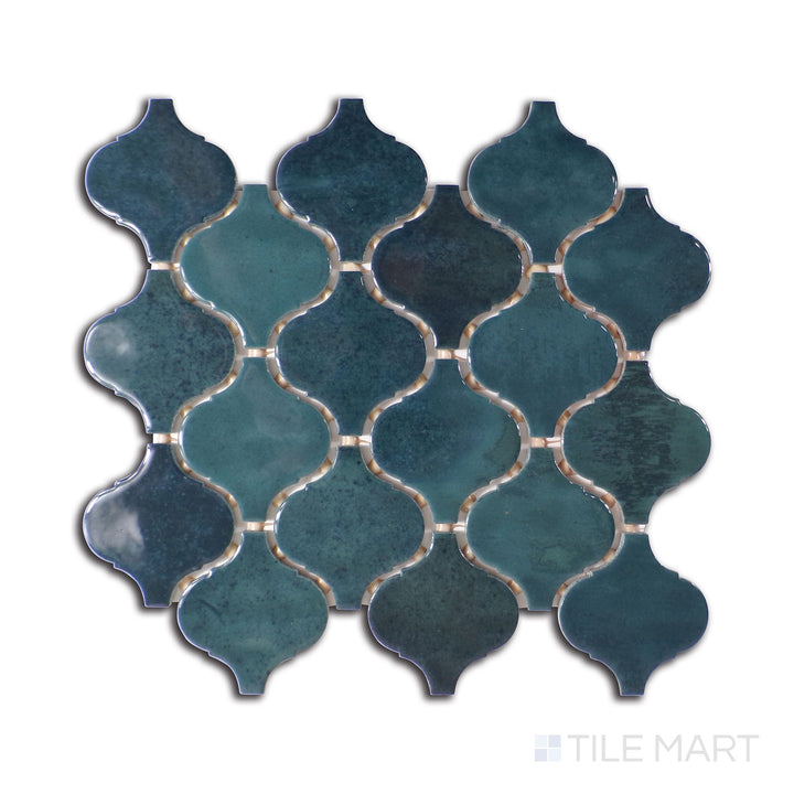 Angled shot of Mesmerist Mystique Arabesque glossy glazed ceramic mosaic, featuring a bold arabesque motif, high-gloss finish, and intricate ceramic detailing.  