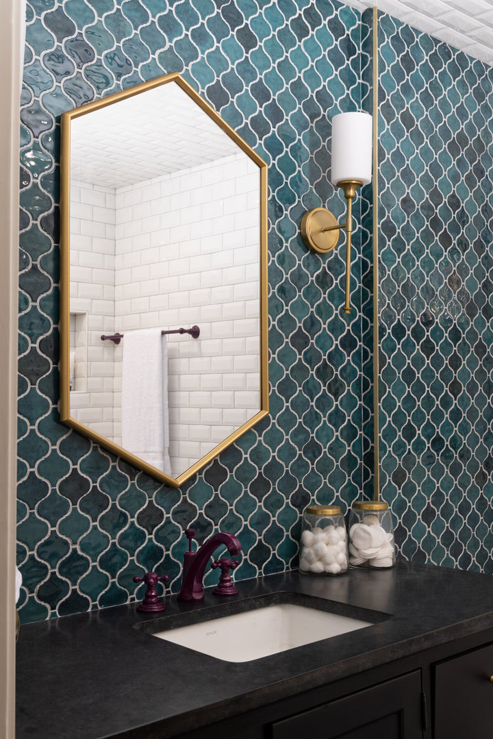 Intricate arabesque designs with a glossy finish enhance the space with a refined touch.