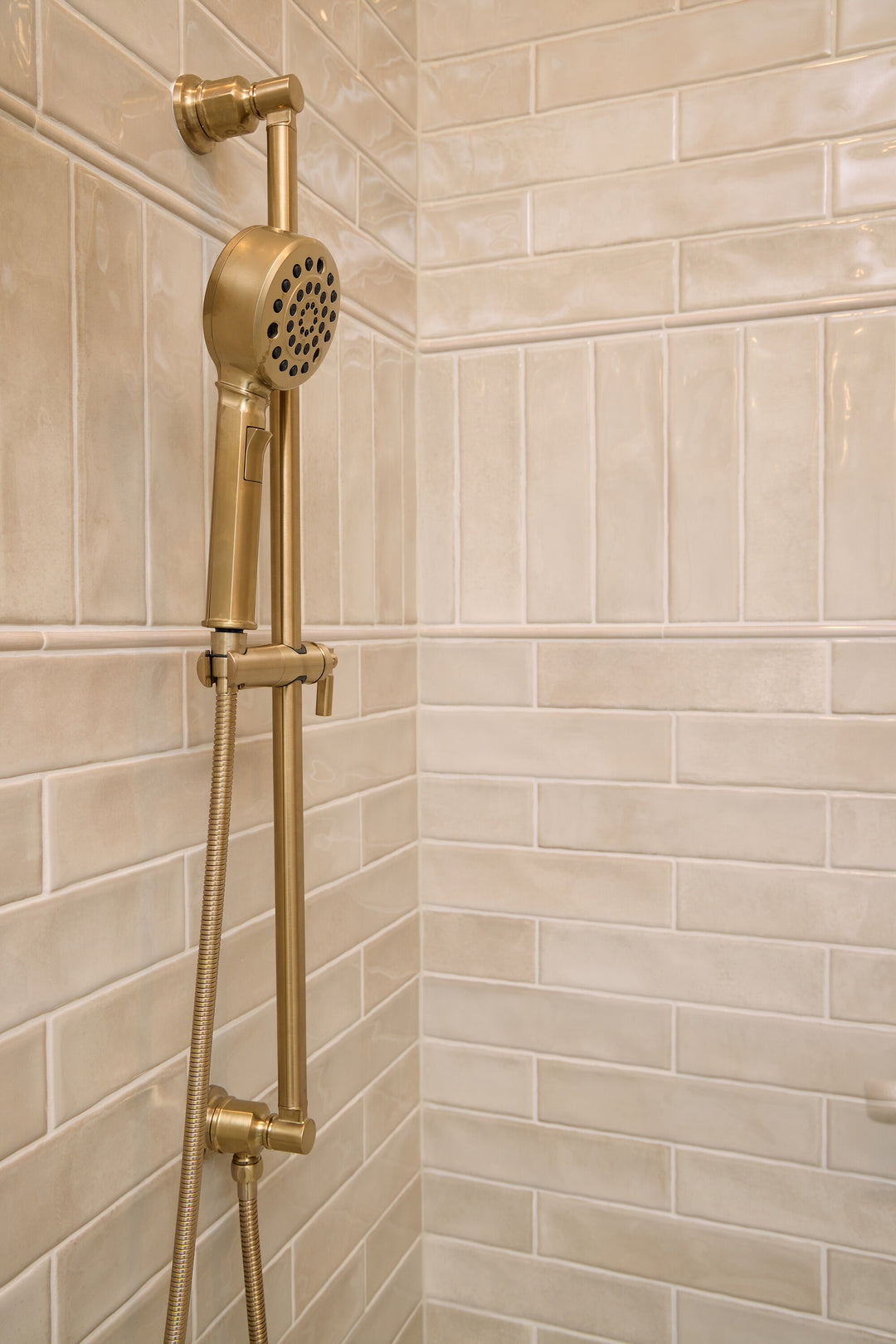 Roomscene of Mesmerist Trance 3x12 glossy glazed ceramic tile featuring a reflective finish and elongated layout that adds depth and shine.