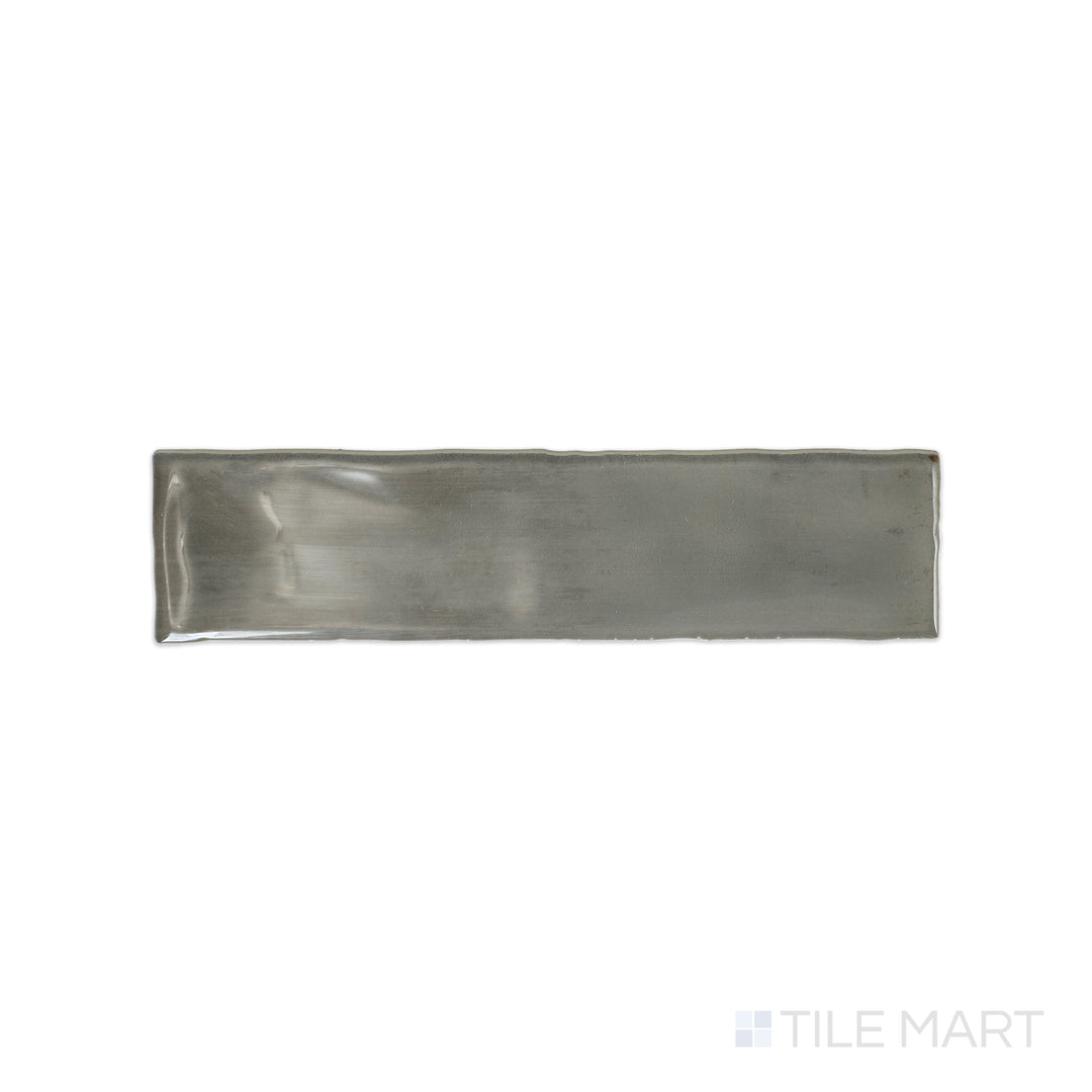 A top-down view of the Mesmerist Charm 3x12 glossy glazed ceramic tile highlights its smooth, polished surface and timeless appeal, perfect for sophisticated wall applications.