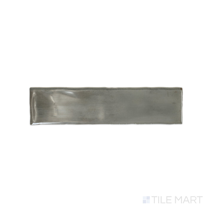 A top-down view of the Mesmerist Charm 3x12 glossy glazed ceramic tile highlights its smooth, polished surface and timeless appeal, perfect for sophisticated wall applications.