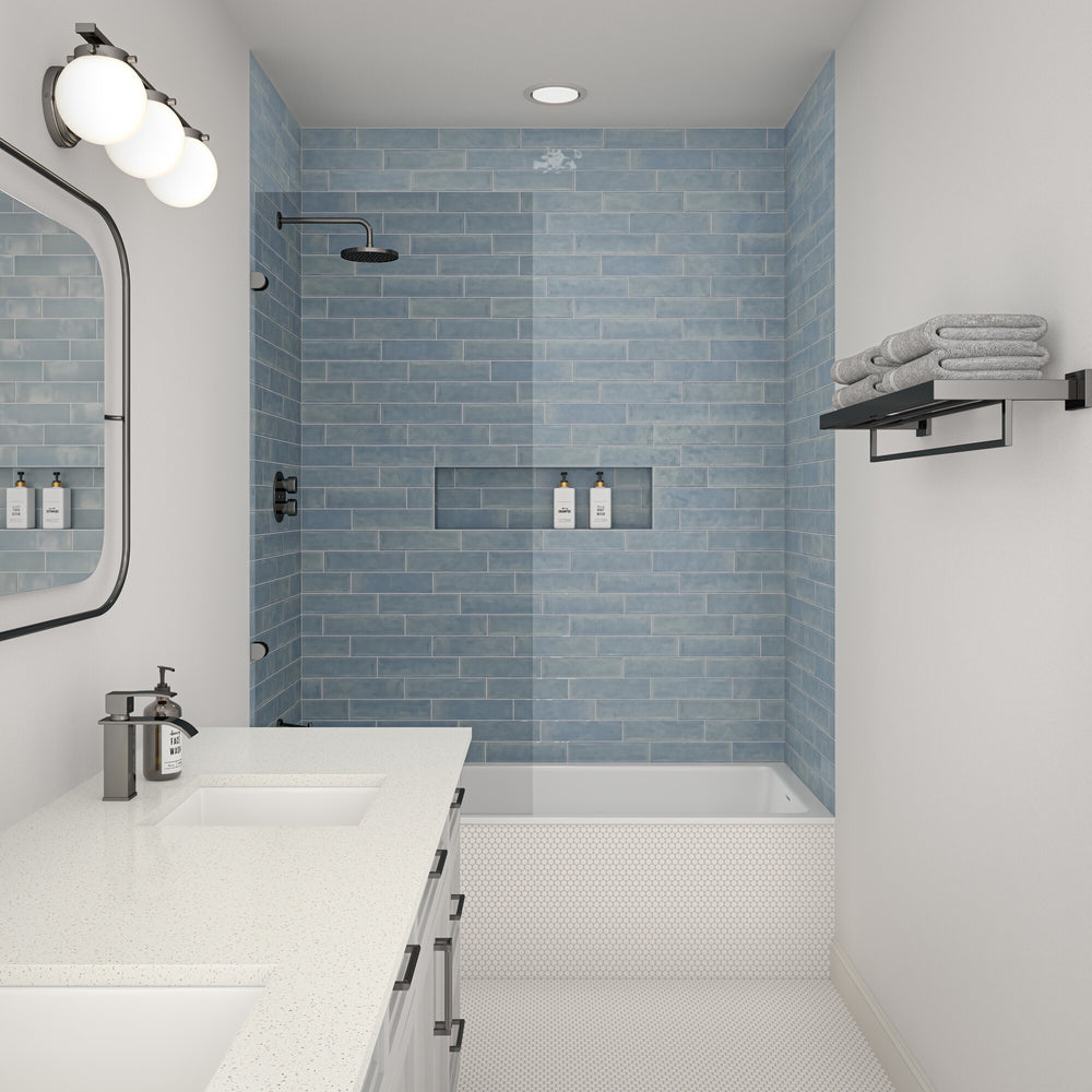 Designed to elevate the space, this roomscene features Mesmerist Whimsy 3x12 glossy glazed ceramic tile with its lively tone and radiant finish arranged in a clean layout.