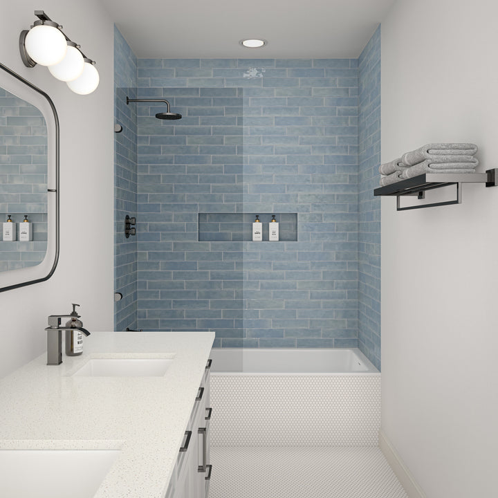 Designed to elevate the space, this roomscene features Mesmerist Whimsy 3x12 glossy glazed ceramic tile with its lively tone and radiant finish arranged in a clean layout.