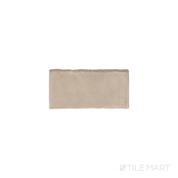 Angled shot of Mesmerist Trance 3x6 glossy glazed ceramic tile, featuring a deep color, high-gloss reflective surface, and a structured rectangular format.  