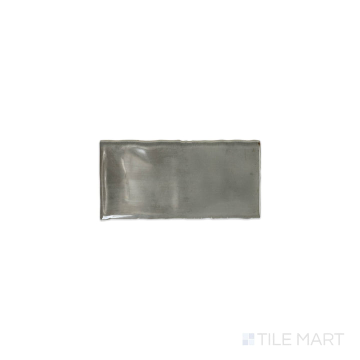 A top-down view of the Mesmerist Charm 3x6 glossy glazed ceramic tile highlights its sleek, polished surface and refined color, adding elegance to walls and backsplashes.