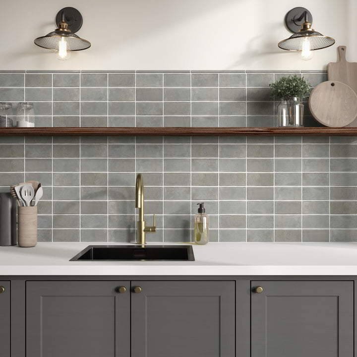 In this styled roomscene, Mesmerist Charm 3x6 glossy glazed ceramic tile brings a classic tile shape to life with smooth gloss and inviting color.