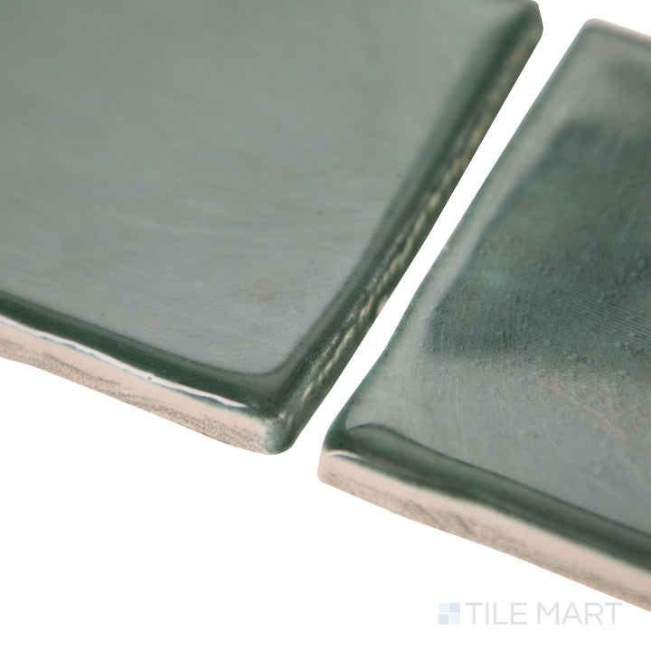 Seen from a corner view, the Mesmerist Allure 3x6 glossy glazed ceramic tile presents a refined glossy surface and linear arrangement.