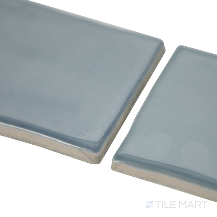 Corner installation of Mesmerist Whimsy 3x6 glossy glazed ceramic tile highlights its polished look and seamless flow along adjoining walls.