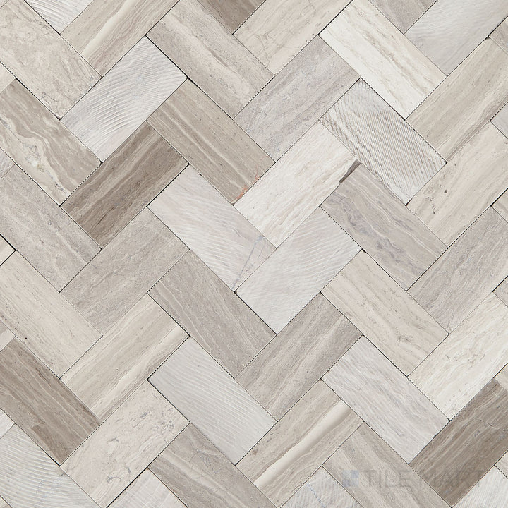 Top-down view of the Minute Mosaix Chenille White Herringbone marble and limestone mosaic, displaying its intricate herringbone layout and natural stone texture.
