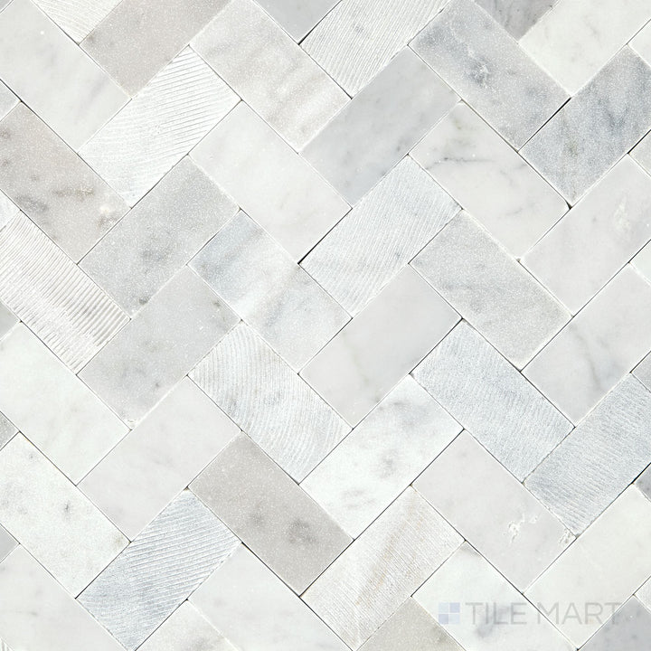 Overhead shot of the Minute Mosaix Carrara White Herringbone marble and limestone mosaic, showcasing its elegant pattern and classic Carrara veining.