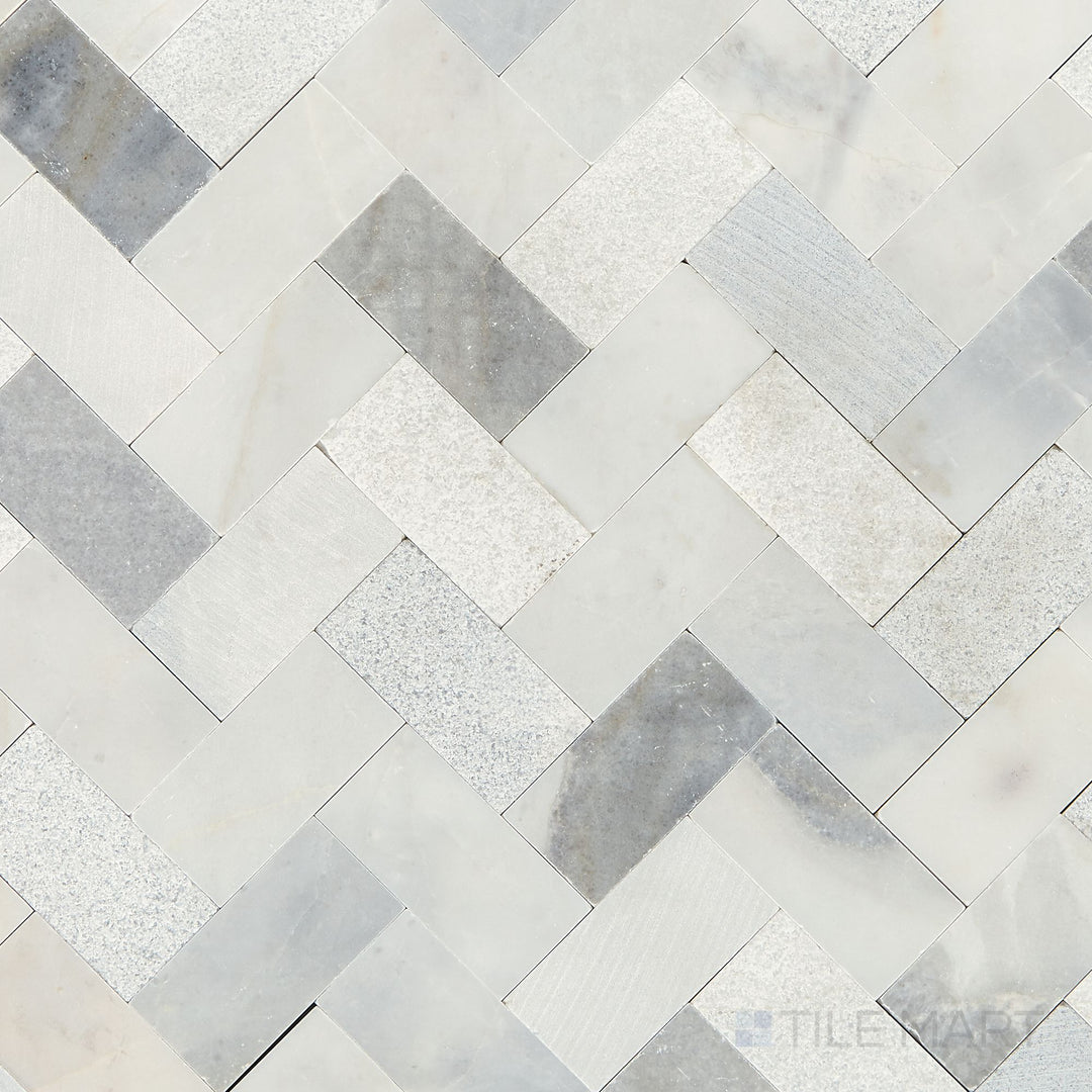 Flat-lay image of the Minute Mosaix Stormy Mist Herringbone marble and limestone mosaic, emphasizing its soft misty tones and interlocking design.