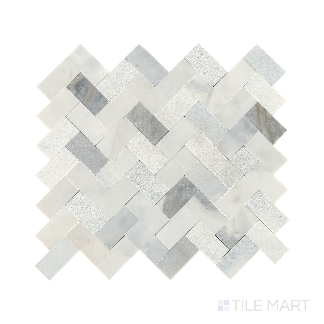 Slanted perspective of Minute Mosaix Stormy Mist herringbone marble limestone mosaic, emphasizing its dramatic gray hues, sophisticated herringbone layout, and textured stone surface.  