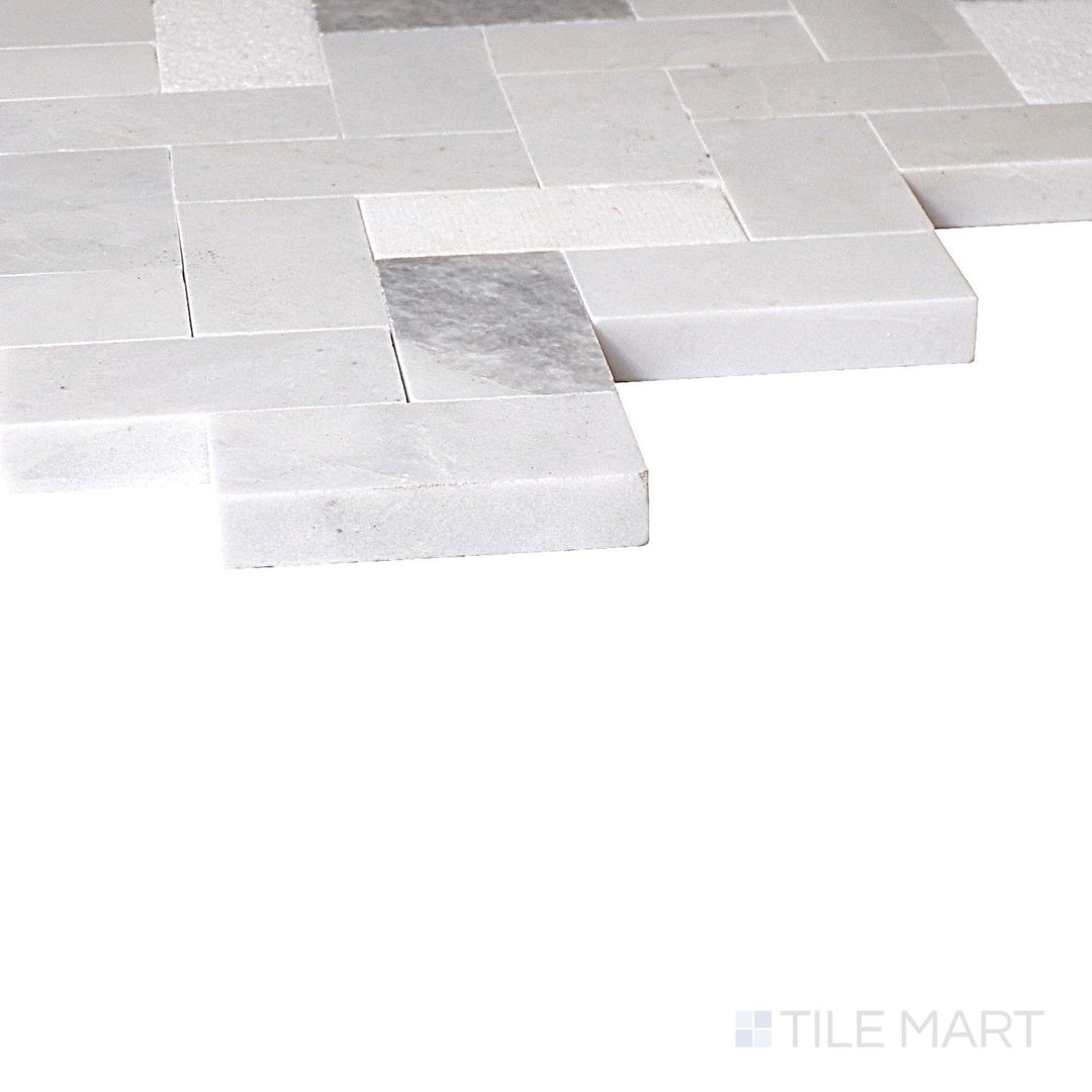 Close-up corner shot of Minute Mosaix Stormy Mist Herringbone Marble, Limestone Mosaic, featuring its cool gray hues with a sophisticated herringbone arrangement.