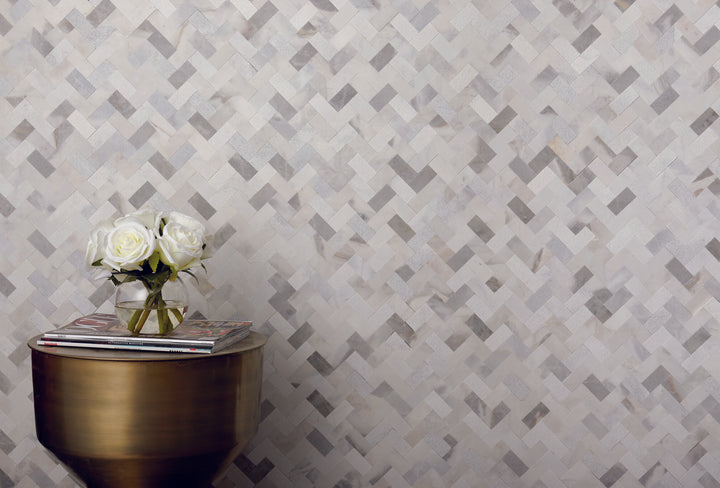Installed in a real-life interior, the Minute Mosaix Stormy Mist herringbone marble and limestone mosaic adds movement and natural stone texture