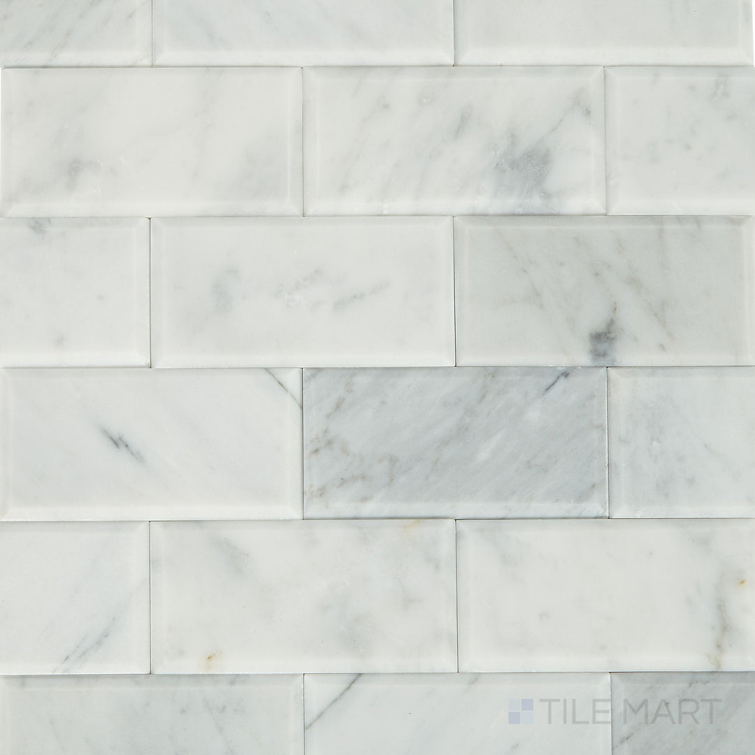 Top-down shot of the Simplystick Mosaix Carrara White Honed marble and limestone mosaic, showcasing its subtle veining and smooth honed surface.