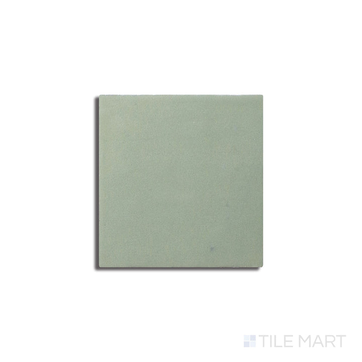 Angled shot of Zellige Neo Turchese 4x4 glossy glazed ceramic tile, featuring a deep turquoise shade, an elegant glossy surface, and a handcrafted appeal.  