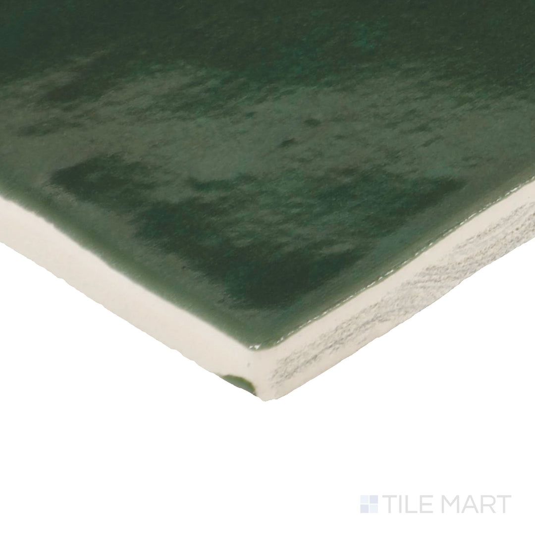 Side perspective of Zellige Neo Bosco 4X4 Glossy Glazed Ceramic Tile, capturing its deep forest green color with a lustrous, handcrafted texture.