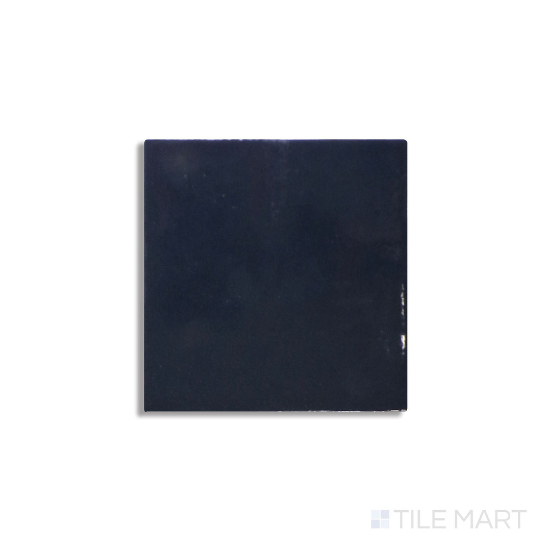 Slanted perspective of Zellige Neo China 4x4 glossy glazed ceramic tile, emphasizing its warm terracotta tone, high-gloss texture, and a slightly rustic, handcrafted feel.  