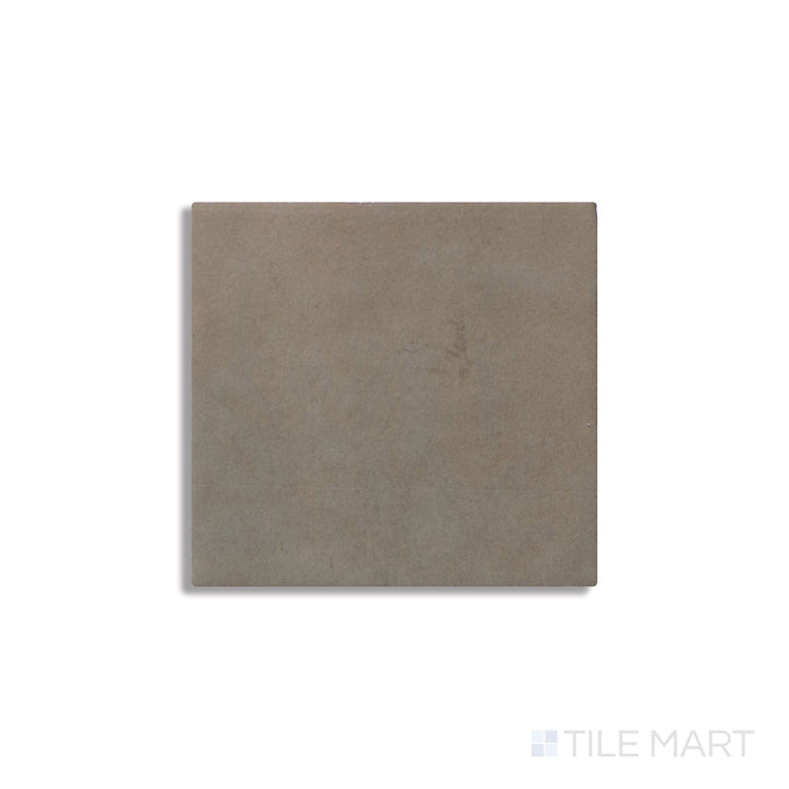 Angled shot of Zellige Neo Argilla 4x4 glossy glazed ceramic tile, featuring an earthy clay-like hue, a glossy glazed coating, and a natural handcrafted effect.  