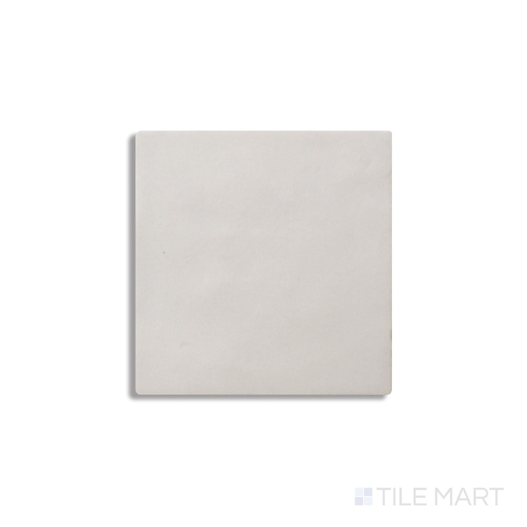 Diagonal view of Zellige Neo Gesso 4x4 glossy glazed ceramic tile, showcasing a crisp white tone, high-gloss surface, and artisanal irregular edges for a handmade aesthetic.  