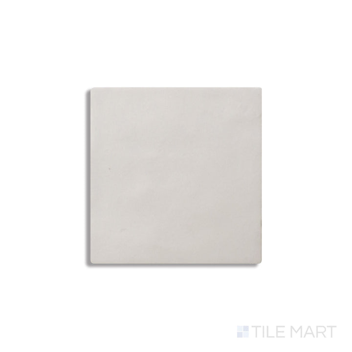 Diagonal view of Zellige Neo Gesso 4x4 glossy glazed ceramic tile, showcasing a crisp white tone, high-gloss surface, and artisanal irregular edges for a handmade aesthetic.  