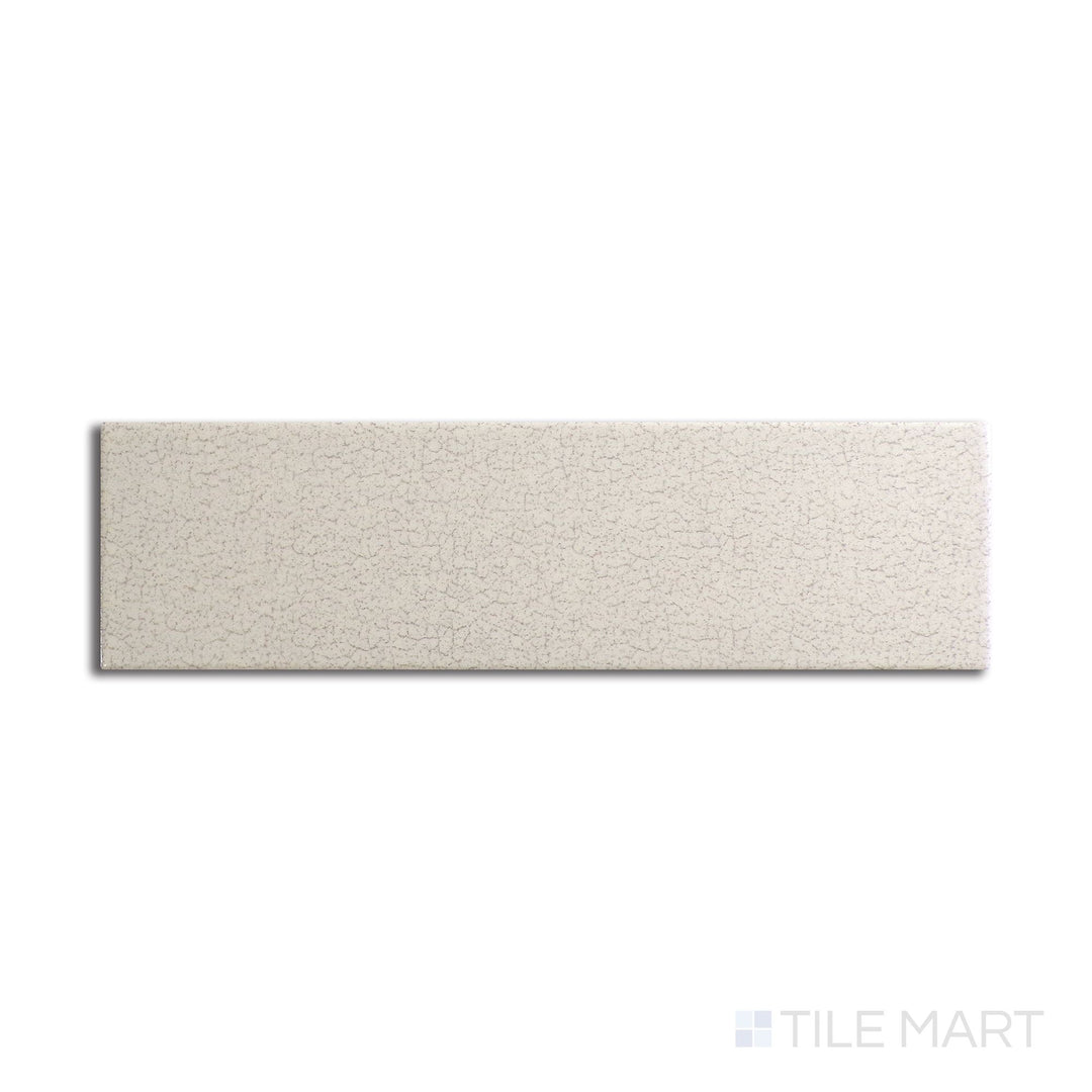 Angled shot of Inyo Crema 2x8 satin glazed ceramic tile, featuring a warm cream hue, smooth satin finish, and sleek rectangular design.  