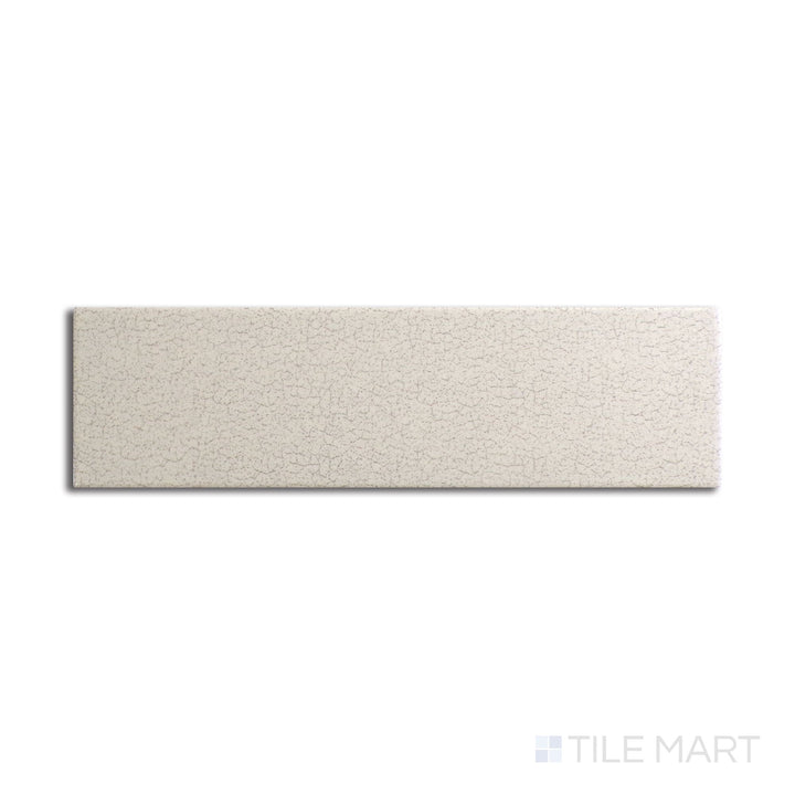 Angled shot of Inyo Crema 2x8 satin glazed ceramic tile, featuring a warm cream hue, smooth satin finish, and sleek rectangular design.  