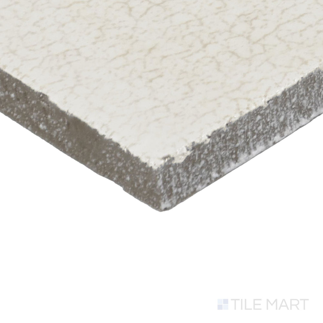 Corner shot of Inyo Crema 2X8 Satin Glazed Ceramic Tile, showcasing its soft cream tones with a smooth satin glaze.