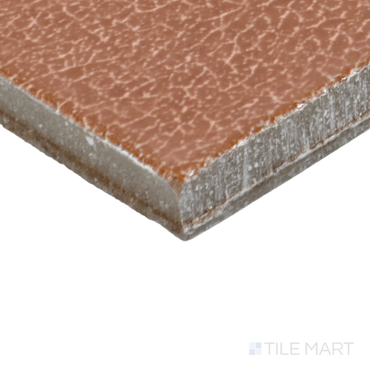 Angled view of Inyo Ember 2X8 Satin Glazed Ceramic Tile, highlighting its warm ember hues with a refined satin finish.