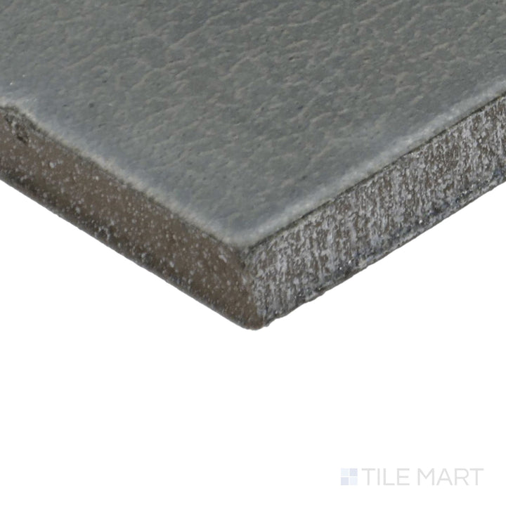 Close-up corner shot of Inyo Olive 2X8 Satin Glazed Ceramic Tile, featuring its earthy olive-green tones with a silky satin glaze.